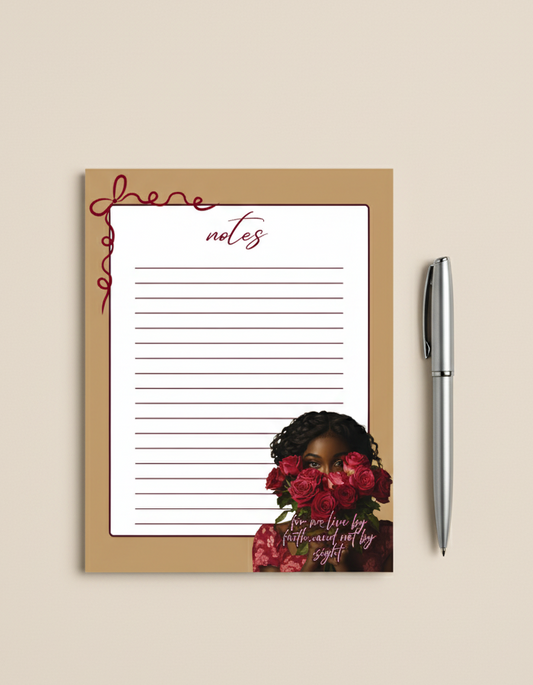 Notebook with floral design and pen on beige background