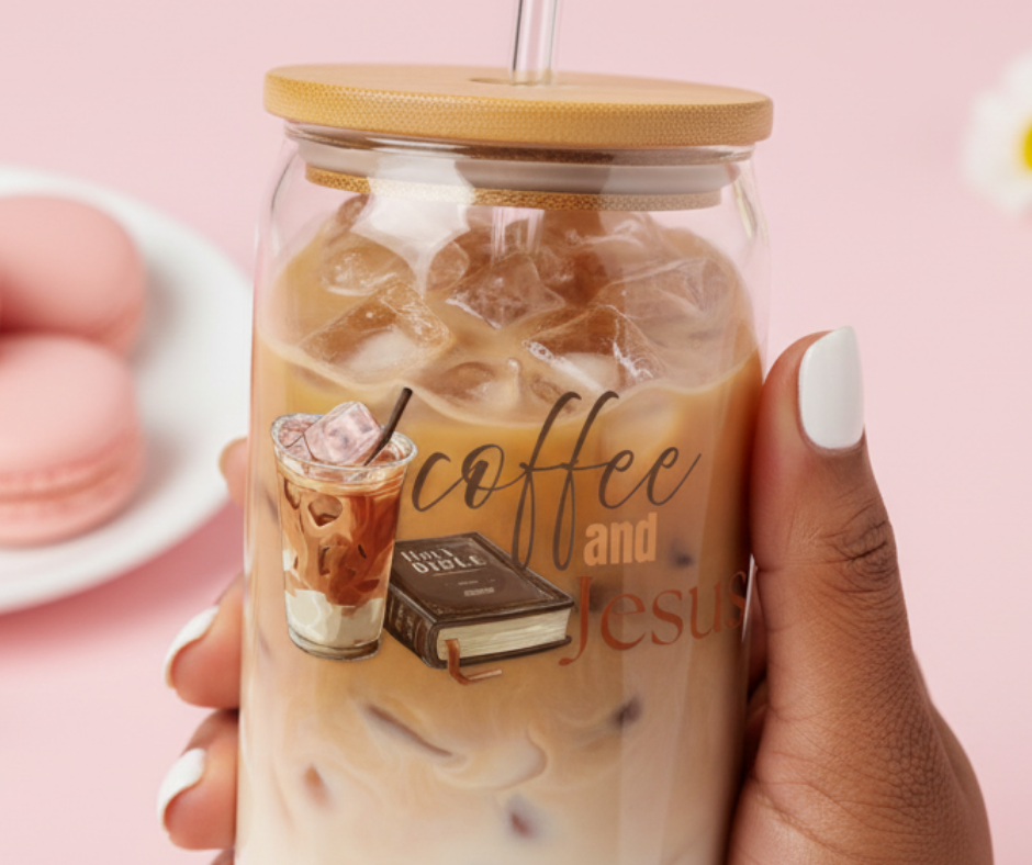 Hand holding a glass of iced coffee with a straw, featuring 'coffee and Jesus' text and graphics.
