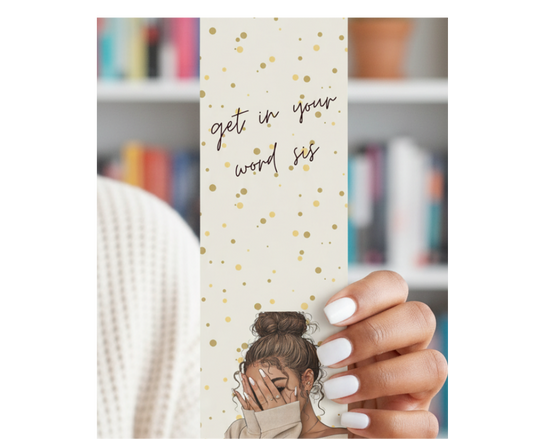 Bookmark with motivational text held by a hand in front of a bookshelf.