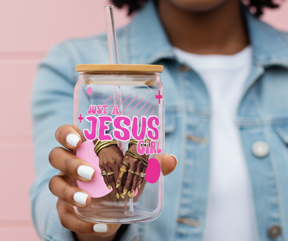 Person holding a tumbler with 'Just a Jesus Girl' text and hands design.