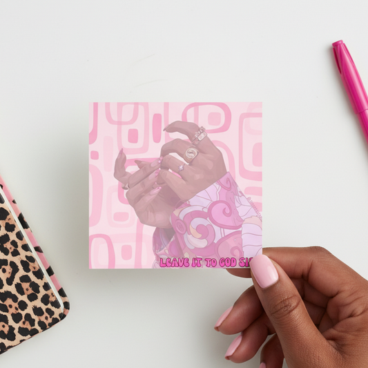 Hand holding a pink card with a hand design and text, next to a pink pen and leopard print notebook.