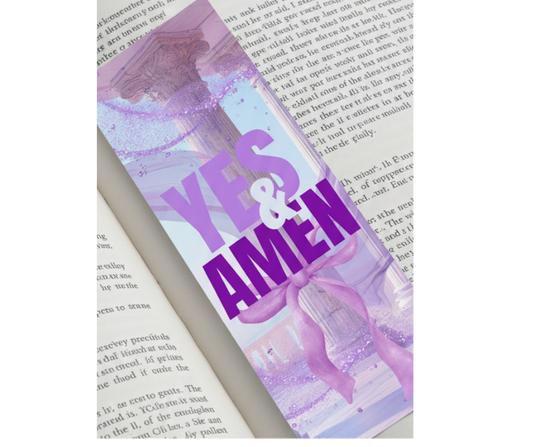 Book with a decorative ribbon labeled 'YES & AMEN' on an open book